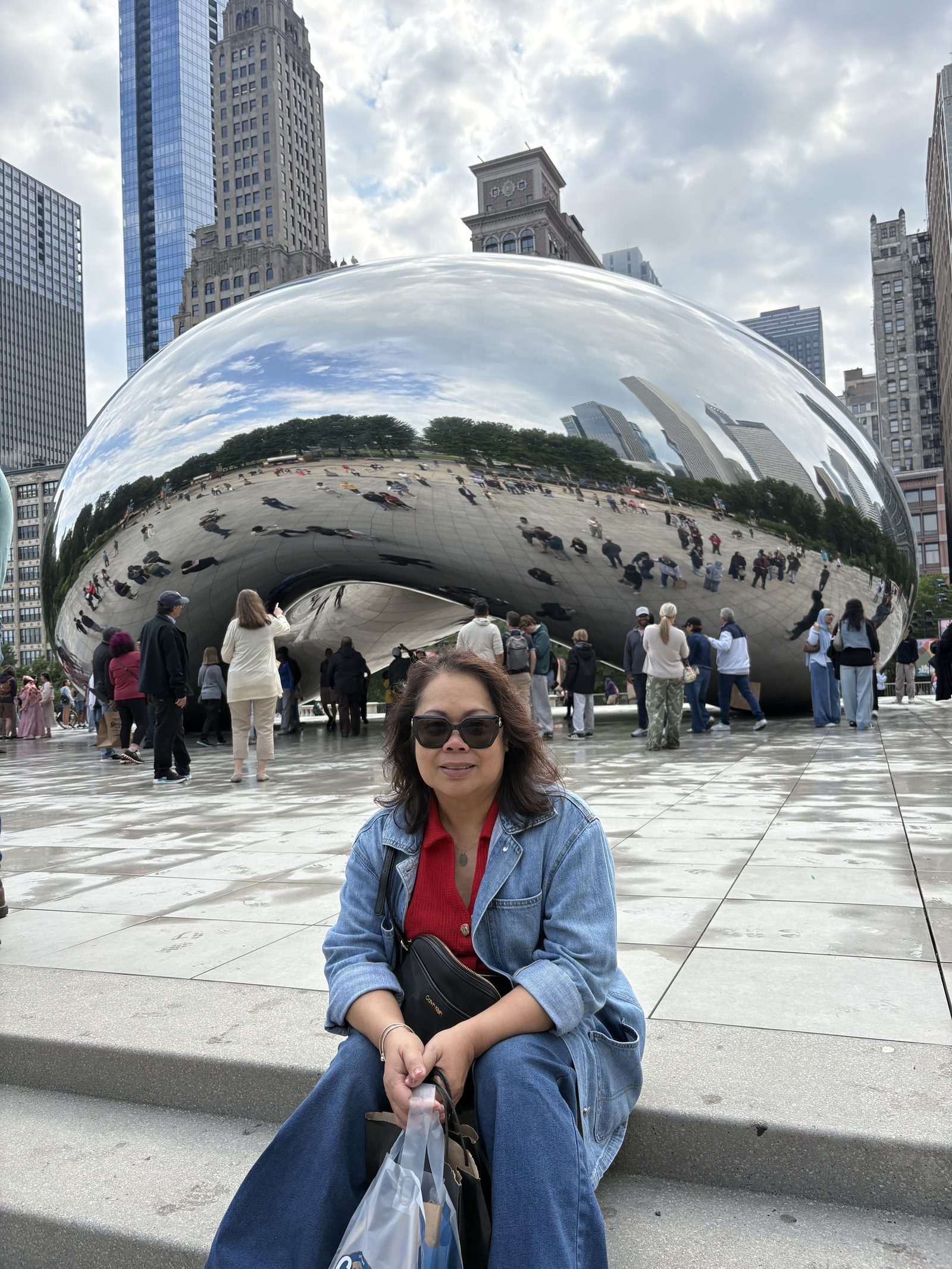 Genalyn standing in front of the mirrored Cloud Gate sculpture in Chicago
